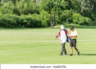 Golfer and caddy on a golf course