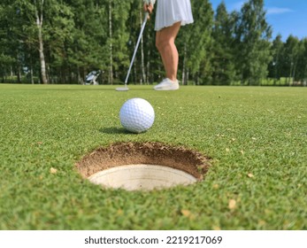 Golfer drove ball into hole and golf course. Golf game - Shutterstock ID 2219217069