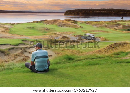a golfer enjoying the view at sunset