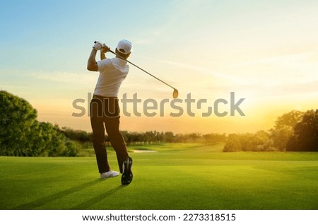 Golfer hit sweeping driver after hitting golf ball down the fairway with sunrise background.