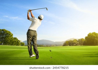 Golfer hit sweeping iron club after hitting golf ball down the fairway. - Powered by Shutterstock