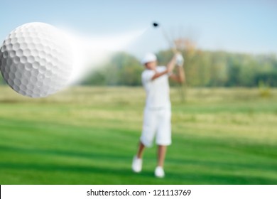 Golfer Hitting A Flying Golf Ball