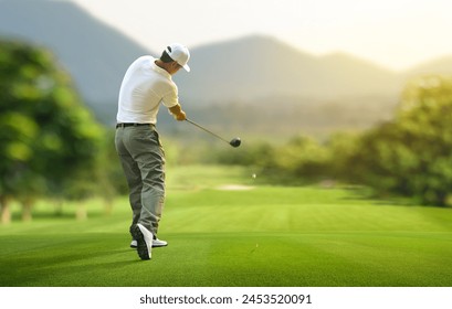 Golfer hitting golf ball with driver to fairway. - Powered by Shutterstock