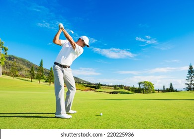 Golfer Hitting Golf Shot with Club on the Course 