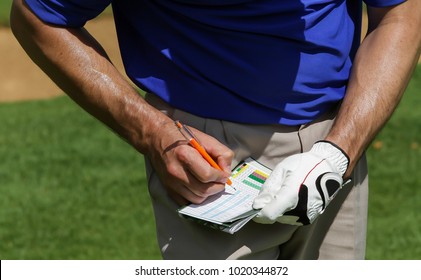 Golfer Keeping Score On Scorecard