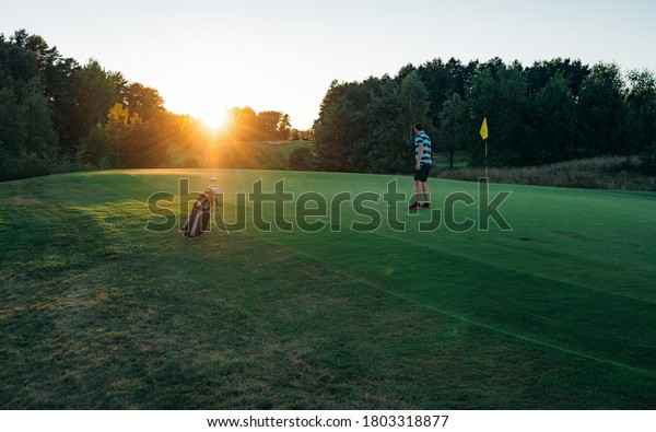 Golfer man\
character playing golf. Beautiful fairway and layout in forest on\
hills or mountain and sky. Green golf and light of sun to beauty\
view for player to happy. Golf sport\
concept
