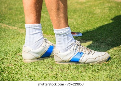 Golfer on golf course, partial view