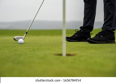 golfer precision strike sends out ball into a hole