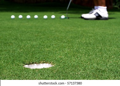 Golfer Putting A Golf Ball