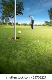 Golfer Putting At Golf Course, Shallow Depth Of Field