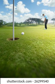 Golfer Putting At Golf Course, Shallow Depth Of Field