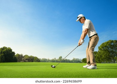 Golfer ready tee-off with drivers on golf teeing ground.