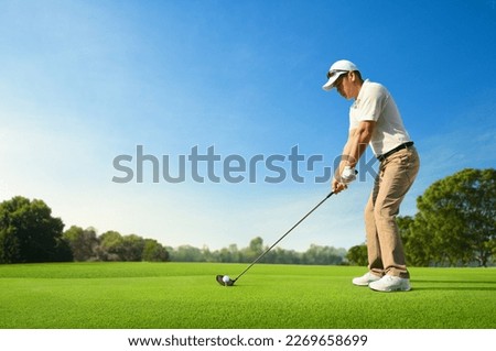 Golfer ready tee-off with drivers on golf teeing ground.