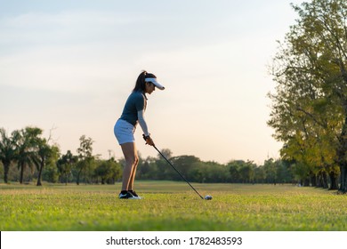 Golfer sport course golf ball fairway. People lifestyle woman playing game golf tee of on the green grass. Asia female player game shot in summer. Healthy and Sport outdoor - Powered by Shutterstock