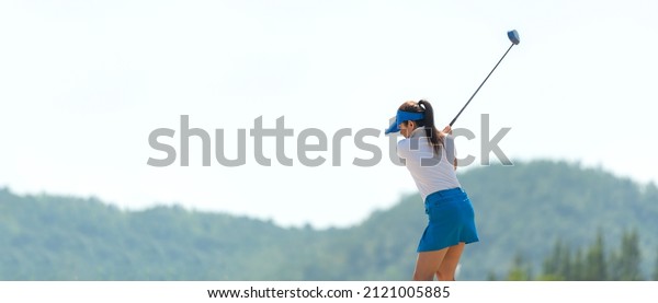 Golfer sport course golf ball fairway. People\
lifestyle woman playing game golf tee of mountain background. Asia\
female player game shot in summer. Healthy and Sport outdoor, copy\
space for banner