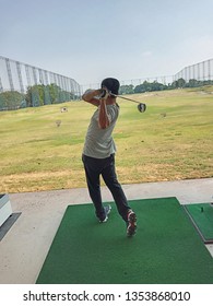 Golfer Swing Practicing At Driving Range