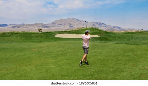 A Golfer Taking His Second Shot From The Fairway