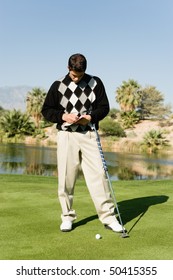 Golfer taking notes on golf course