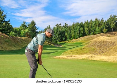 A Golfer Teeing Off On A Beautiful Course