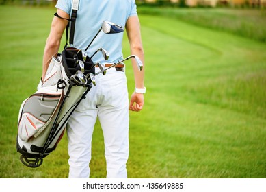 Golfer Walking With Golf Bags