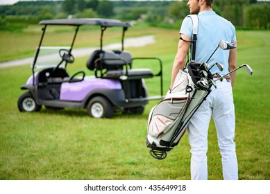 Golfer Walking With Golf Bags