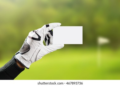 Golfer Wearing Golf Glove Show Blank Business Card On Golf Course Blur Background