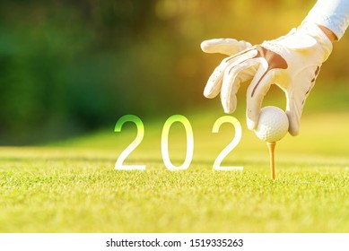 Golfer Woman Putting Golf Ball For Happy New Year 2020 On The Green Golf For New Healthy Sporty, Copy Space. Healthy And Holiday Concept.