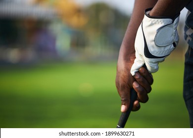 Golfer's hand holds the golf club in preparation for the hit. - Shutterstock ID 1899630271