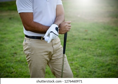 Golfers are holding a golf ball - Powered by Shutterstock