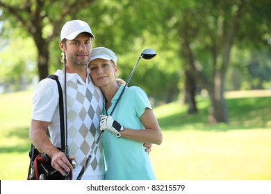 Golfing Couple Hugging On A Course