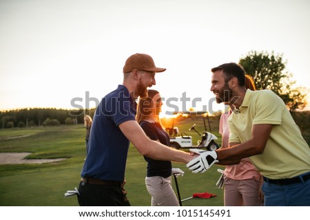 Golfing partners shaking hands after a game of golf