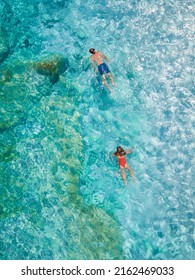 Golfo Di Orosei Sardina, Men And Women On The Beach Sardinia Italy, Young Couple Vacation Sardinia Italy, Couple Men And Woman Playing In The Ocean With Crystal Clear Blue Water In Italy