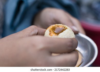 golgappe or phuchka or paani puri, served on plate with stuffing of aloo and other chaat items along with sweet and sour tamarind mint water. it is a famous indian streetfood eaten by hand. 