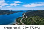 Golo Mori – Labuan Bajo Super Premium Tourism Destination where Asean Summit will held. Aerial view of a road in green meadows and hills with beach and mountains. Road to Golo Mori Mice.