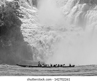 Golondrina falls and tourists boat in the lagoon of Canaima national park - Venezuela, Latin America (black and white) - Powered by Shutterstock