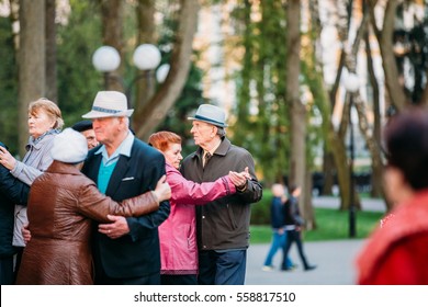 Gomel, Belarus - April 17, 2016:  Dancing Pair In Years On Outdoor Dance Floor Among Dancing Solus Elderly People In Summer Amusement Park In Gomel, Homiel, Belarus