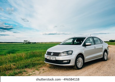 Gomel, Belarus - June 13, 2016: Volkswagen Polo Car Parking On A Roadside Of Country Road On A Background Of Green Spring Fields Or Meadow