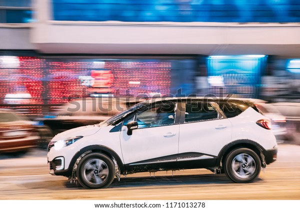 Gomel,\
Belarus - March 4, 2018: White Color Renault Kaptur Car Driving In\
Night Winter Street.  The Subcompact Crossover Renault Kaptur\
Produced Jointly By Renault–Nissan\
Alliance