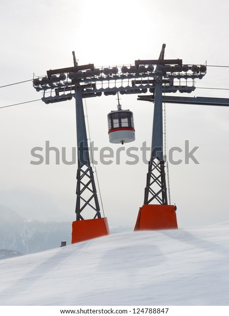 Gondola between two ski lift pylons at Kronplatz\
Ski Resort, South Tyrol,\
Italy