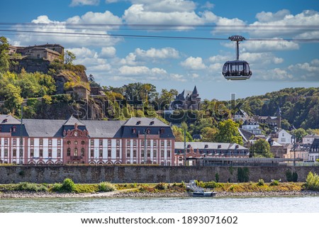 A gondola of the cable car across the river Rhine in Koblenz, Germany, with the fortress and ancient buildings in the background