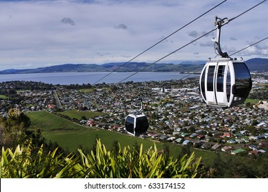 Gondola cable car lift ride up above Rotorua lake and Rotorua town landscape below in the center of North Island of New Zealand.