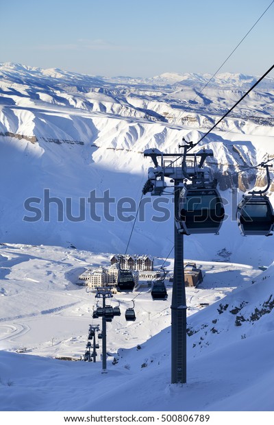 Gondola lift on ski resort at sun\
evening. Greater Caucasus, Mount Shahdagh,\
Azerbaijan.