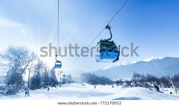 Gondola lift at ski resort in winter. Pirin\
Mountains. Ropeway station in\
Bansko