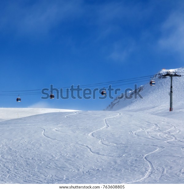 Gondola\
lift and ski slope for freeriding in fog at sun evening. Caucasus\
Mountains in winter, Georgia, region\
Gudauri.