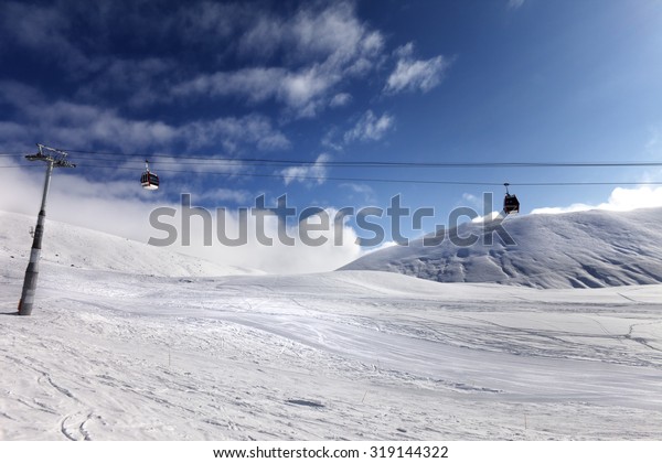 Gondola lift and ski slope.\
Georgia, ski resort Gudauri. Caucasus Mountains. Wide angle\
view.