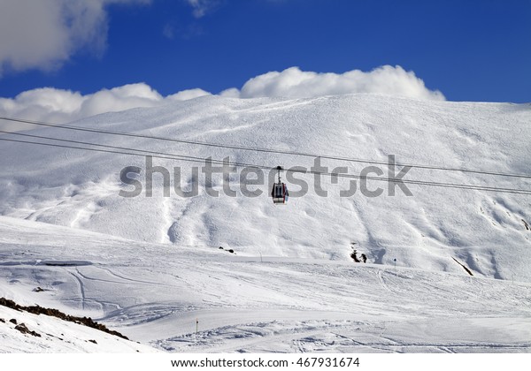 Gondola lift and ski slope at sun day.
Caucasus Mountains, Georgia. Ski resort
Gudauri.