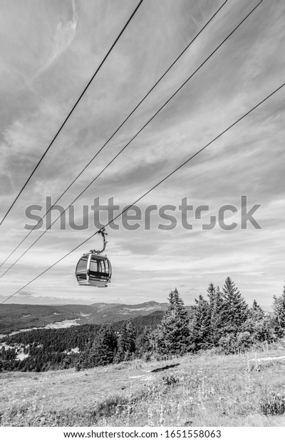 The gondola lift is\
suspended high