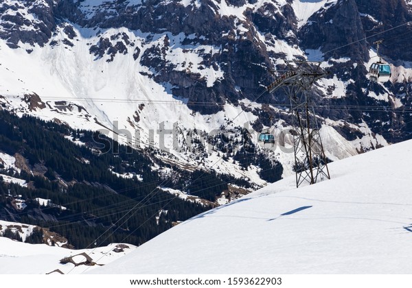 Gondola lift with tower from\
Grindelwald to First peak cable car station , Bern Switzerland\
Europe