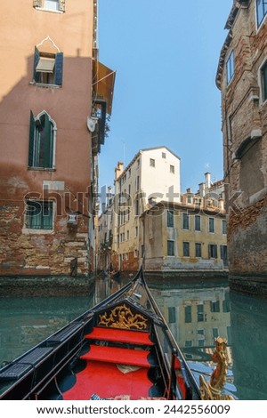 Gondola ride through the canals with view from inside the boat at the typical facades, Venice, Veneto, Italy