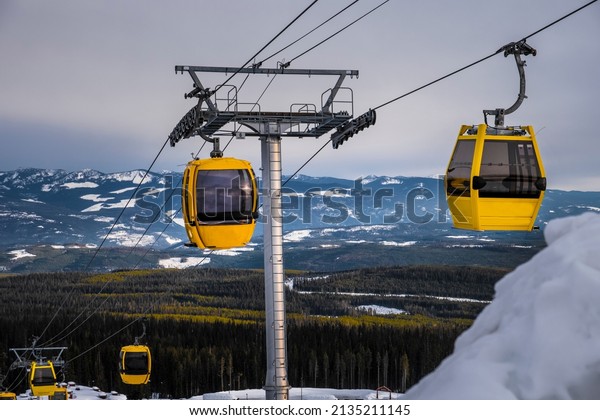 Gondola at ski resort. Chair lift with view of\
snowy mountains. Beautiful winter day at Big White Ski Resort.\
Kelowna. British Columbia.\
Canada.